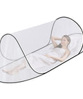 Ultra Portable Pop Up Mosquito Tent For Camping And Travel Easy Foldable Mesh Net That Fits A Full Size Bed with person inside.