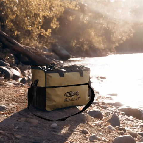 Vented Wader Bag With Mesh Panels For Fishing And Hunting, Water Resistant 108L Gear Tote on rocky riverbank