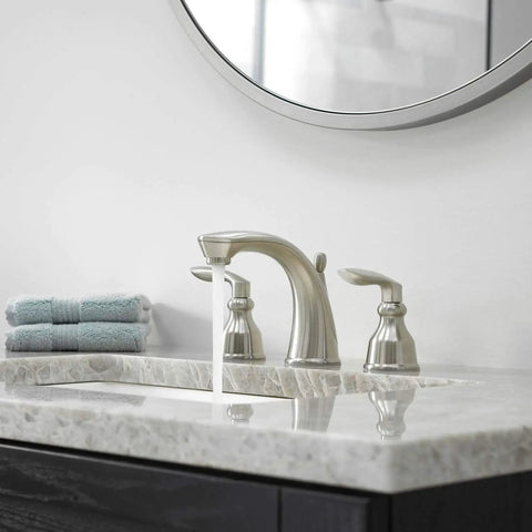 Avalon Two Handle 8 Inch Widespread Bathroom Faucet in Polished Chrome, deck mount displayed on a modern vanity with round mirror