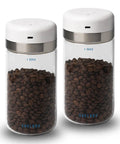 Keep Your Beans Fresh As A Daisy With This Smart Electric Vacuum Seal Coffee Canister And Airtight Storage Jar For Whole Ground Roasts Real Deal Smooth Push Button Operation Durable Borosilicate Glass, two jars filled with coffee beans.