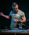Deluxe Carbon Fiber Cleaning Rod For.27 To.45 Caliber Rifles, 40 Inch Length, in use for gun maintenance on a workbench