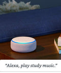 Hella Compact Smart Speaker With Alexa Built In Drops Kickass Soundwaves Smooth For Cozy Rooms Stereo Pairing Ready Charcoal Shell on wooden table.
