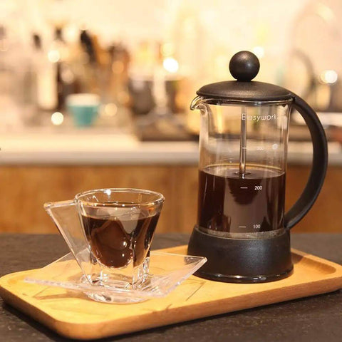 French Press Coffee And Tea Maker 12 Oz with borosilicate glass and four level filtration system on a wooden tray
