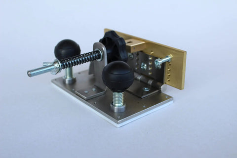 Knife Bevel Jig With Center Scribe Edge For Precision Grinding And Accurate Bevel Alignment shown on a work table.