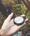 Wicked Compact Map Measure Wheel And Ridiculously Light Distance Calculator For Hiking Camping Trekking Trail Running And Road Trips Sleek Navigation Gear in hand with measuring scale.