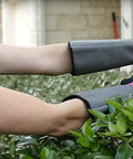 Woman pruning bush wearing Rose Pruning Gardening Gloves For Women With Long Sleeve Cuff, Thorn Resistant, Pink, Extra Long Wrist Protection.