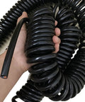 Heavy Duty Retractable Twin Spiral Extension Cord With Four 2.5 Mm Conductors Stretching Up To Ten Meters, coiled in hand.
