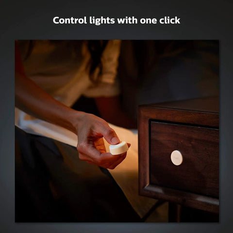 Hand using Wireless Smart Light Switch Button Battery Powered And Portable White Remote For Easy No Wire Setup