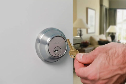 SmartKey Security Exterior Deadbolt With Keyed Entry In Satin Nickel Model 980 installation on door with hand and key