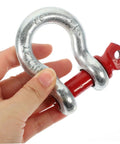 Close-up of Heavy Duty Galvanized Steel Lifting Shackles Two Pack Iron Strong Hardware Built Tough For Truck Towing Off Road Recovery Quick Release Pin Heavy Load Haulin Operations held in hand.