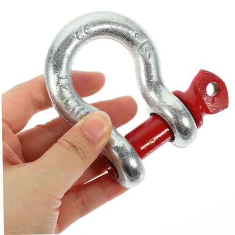 Close-up of Heavy Duty Galvanized Steel Lifting Shackles Two Pack Iron Strong Hardware Built Tough For Truck Towing Off Road Recovery Quick Release Pin Heavy Load Haulin Operations held in hand.