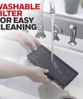 Hands washing a filter from QuietClean Tower Air Purifier For Medium Rooms Up To 170 Sq Ft With Permanent Washable Filters
