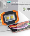 Rechargeable LED Work Light 30W 1500LM Portable Flood Light On The Go with Magnetic Base charging a phone