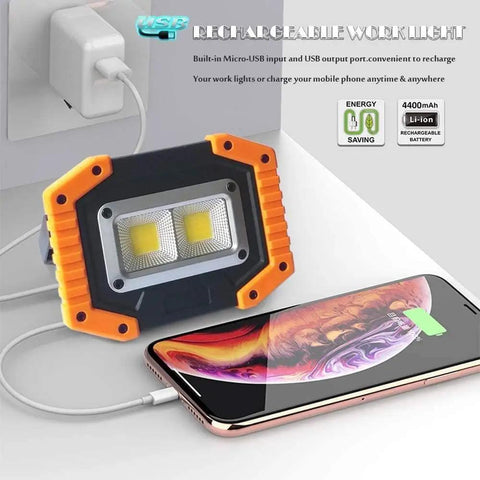 Rechargeable LED Work Light 30W 1500LM Portable Flood Light On The Go with Magnetic Base charging a phone