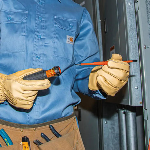 Technician using interchangeable insulated flip blade with slim tip for tight terminal blocks, wearing protective gloves.