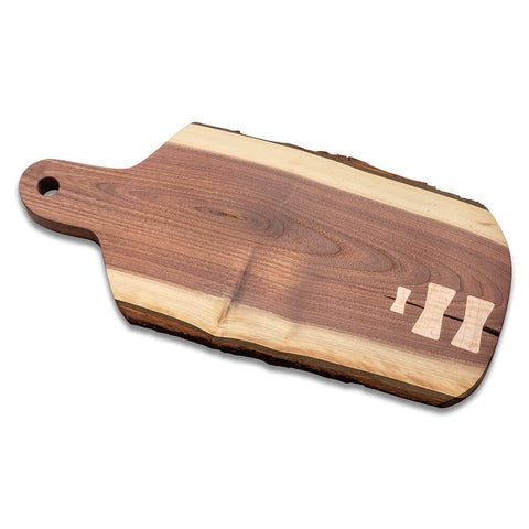 Wooden cutting board with three decorative bow tie inlays on one side, showcasing the Bow Tie Inlay Kit With Frame, Bit, And Bushing.