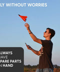 Man launching paper airplane using smartphone, featuring 4.0 Accessory Kit For Smartphone Controlled Paper Airplanes - Landing Gear For Takeoff And Landing.