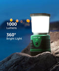 Bright 1000 Lumen Rechargeable Go To Camping Lantern With 4400mAh Power Bank Green LED Tent Light on rocks at dusk