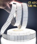 Hands holding Quad Row 24V DC LED Strip Light Daylight White 90 CRI Flexible Tape 5m 16.4ft 17,650 Lumens, emitting bright light