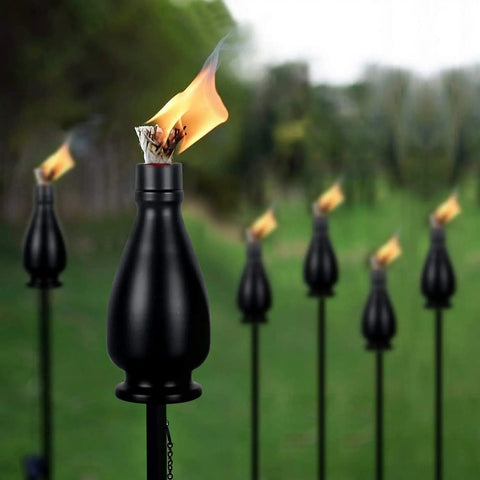 Citronella Torches 6 Pack for Outdoor Lighting, 60 Inch Jet Black Metal Pathway Torches With Flickering Flame in garden setting
