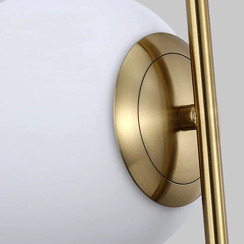 Close-up of Dope 2 Light Globe Pendant Lighting with white glass shade and brass gold metal accent