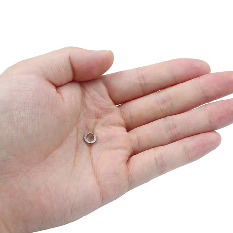 Split lock washer #8, stainless steel, silver, held in open palm