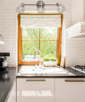 Cedrick 3 Light Track Lighting in brushed nickel with adjustable heads over a kitchen sink.