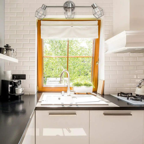 Cedrick 3 Light Track Lighting in brushed nickel with adjustable heads over a kitchen sink.