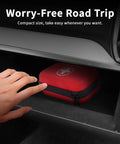 Compact red waterproof hard-case first aid kit in car glove box