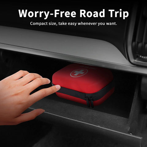 Compact red waterproof hard-case first aid kit in car glove box