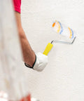 Person using a mini paint roller cover on a textured wall, showcasing the Twenty Piece Mini Paint Roller Covers For Hassle Free Wall Painting Quick Rinse And Sweet Smoothing Finish Perfect For Tight Spaces And Easy Diy Refreshes.