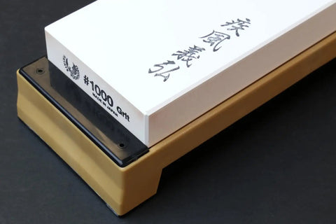 Pro Grade Japanese Whetstone Sharpener 1000 Grit Water Stone with yellow base on black background
