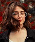 Woman wearing eyeglasses with Three Six Ten Pack Eye Glasses Side Shields Slip On TPU Guards, outdoors with red flowers background