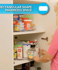 Woman using Smart Spin Rotating Refrigerator Organizer Lazy Susan for pantry storage, showing rectangular shape for space-saving organization.