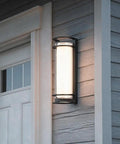 ROPCVAX Led Wall Sconce Lighting Fixture Lamp Modern Minimalist Aluminum Black illuminates entryway with cylindrical shade.