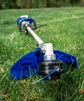 Close-up of Gas Powered 26cc Weed Wacker 3 In 1 String Trimmer Edger with 10 Inch Brush Cutter on grassy lawn.
