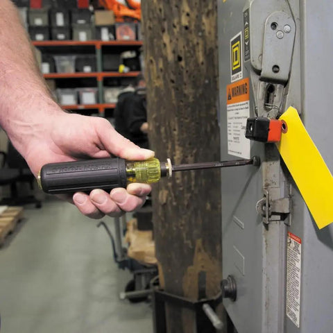 Man using Adjustable 4 To 8 Inch Screwdriver With Removable Shaft Dual Tips Phillips Size 2 And One Quarter Inch Slotted Made In USA on electrical panel