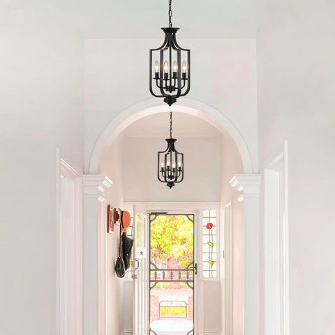 10.63 Inch Black Farmhouse Chandelier with Four Lights installed in hallway, showcasing rustic metal cage design and adjustable E12 base.