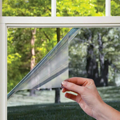 Hand applying Heat Control Platinum Window Film For DIY Install Energy Saving Sun Blocking Tint That Slashes Heat Blocks 99 Percent UV