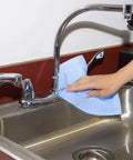 Person cleaning sink with Blue V40 Value Series Center Pull Wiper Sheets All Purpose Disposable Cleaning Towels 10 X 11.5 Inches Roll Of 200