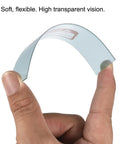 Clear Welding Protection Lenses 4.3 X 3.5 Inch, flexible right angle replacement shield for solar weld helmets, held between fingers.