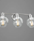 Three Light Coastal Vanity Light With Clear Glass Shades In Polished Nickel Finish Mounted on Wall