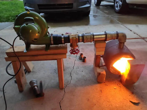 Electric Blacksmith Forge Blower 110V 250W for coal fires shown in use, connected to forge with flame, on wooden support