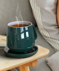 Tempered Glass Top Cup Warmer Pad With Digital Display And Auto Timer To Keep Your Morning Brew Piping Hot And Dodge The Cold Coffee Blues On Busy Weekdays with steaming cup on side table.