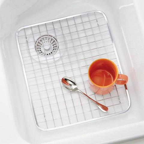 Stainless Steel Sink Grid Protector Kitchen And Bath Rugged Dish Rack in sink with orange mug and spoon, 12.75x11 inches.