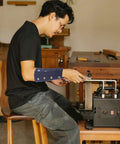 Man using Heavy Duty Cut Proof Arm Sleeves For Yard Work And Backyard Grind Plus Bite Resistant Wrist Guards while working on tools.