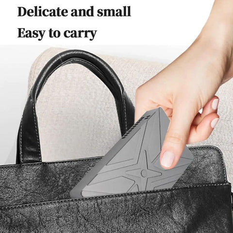 Hand holding a small Rock Solid Dual Bay M.2 NVMe SSD RAID Enclosure, easy to carry in a black bag.