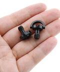 Close-up of a hand holding two Three Pack Stainless Steel D Ring Camera Screws One Quarter Inch Quick Release Tripod Nut For Cameras.