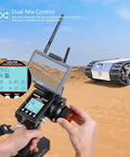 RC4GS V3 2.4G 5 Channel RC Transmitter And Receiver With Built In Gyro for crawler trucks, held with desert background