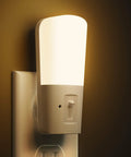 Dimmable LED Plug In Night Light With 5 To 80 Lumens Brightness And Dusk To Dawn Sensor glowing in dark room, soft white 3000K.